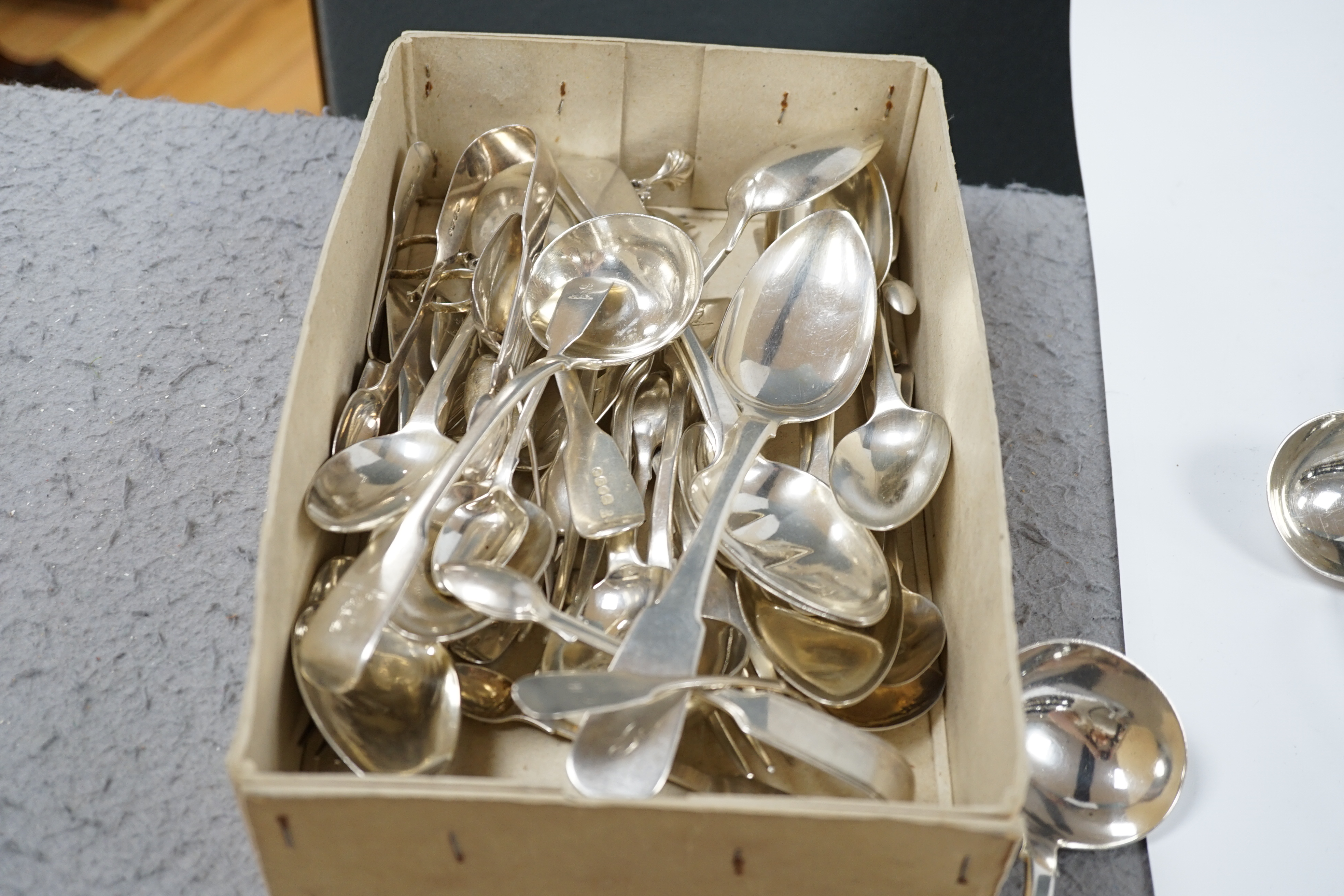 A quantity of assorted mainly 19th century silver flatware, including sauce ladles, table spoons, caddy spoon and sugar nips, various dates, patterns and makers, 59.4oz. Condition - poor to fair
